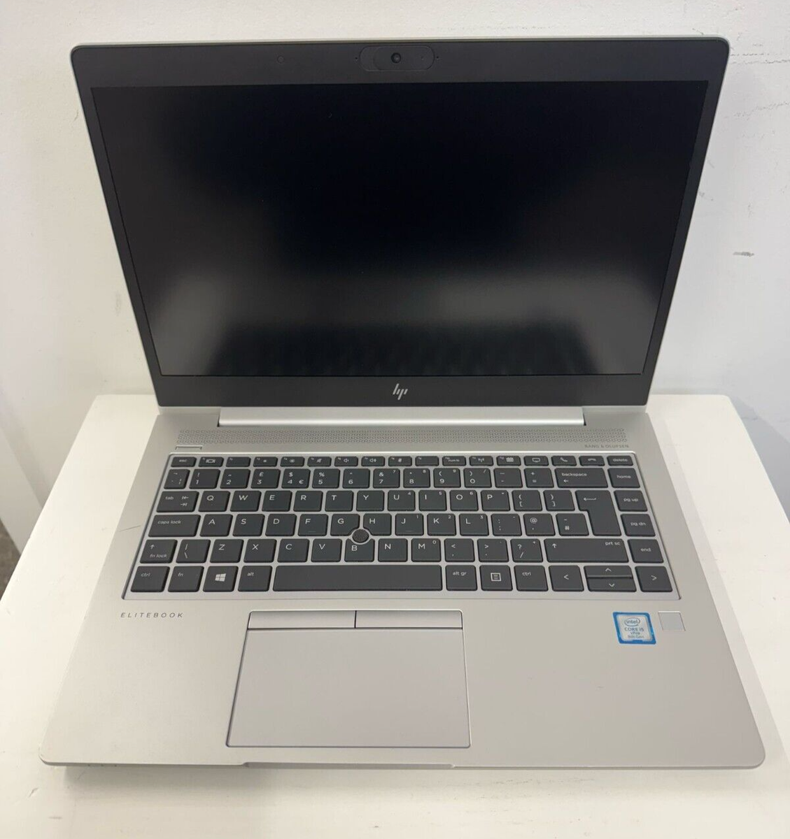 An HP EliteBook 840 G5 | Intel Core i5 laptop with a silver body and black screen is open on a white surface, displaying its keyboard and touchpad.